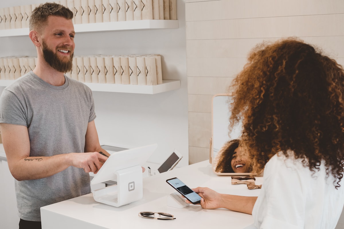 Customer paying with a card at a retail counter